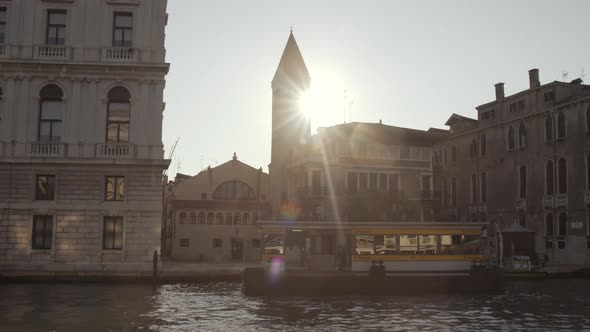 Wide shot of Samuele tower revealing sun that flares the lens, Venice, Italy