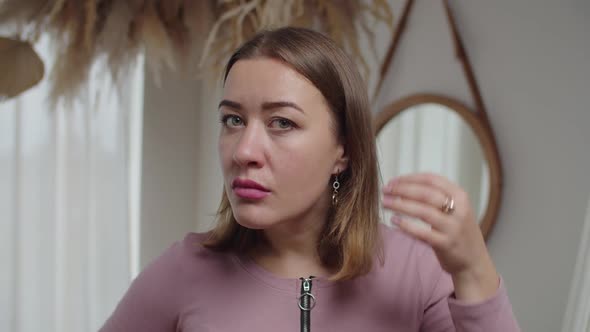 Lovely Adult Woman Looking for Gray Hair in Mirror Scared of Premature Aging Signs