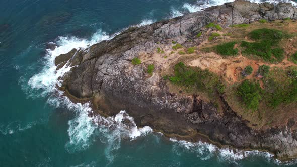 Aerial view of seacoast view in phuket island.Beautiful sea surface Amazing waves crashing on rocks