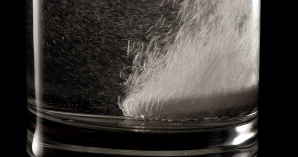 4K - Aspirin in a water glass. Macro shot