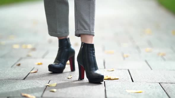 Elegant Female Leather Shoes on Slender Legs, Closeup View of Stepping Feet on Tiled Ground