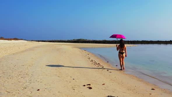 Tourists enjoying life on luxury seashore beach wildlife by blue ocean and white sand background of 