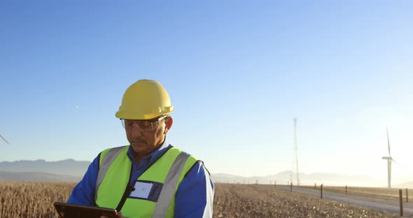 Engineer using digital tablet in the wind farm 4k