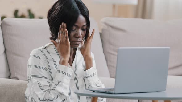 Stressed Young Tired Woman Freelancer Businesswoman Working Remote on Laptop at Home Holding on Head