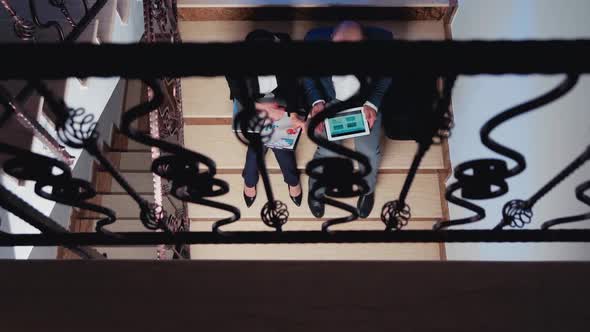 Top View of Company Manager Arguing Businessman on Stairs