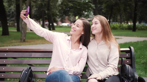 Happy Young Girls Students Friends Making a Selfie or Video Call to Friends or Relatives Outdoor