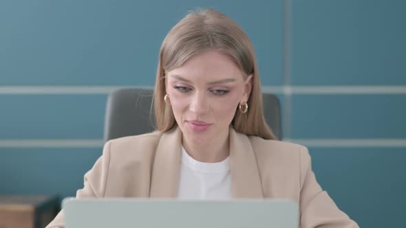 Close Up of Businesswoman Talking on Video Call on Laptop in Office