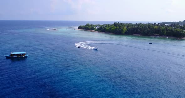 Tropical drone travel shot of a sunshine white sandy paradise beach and blue ocean background in col