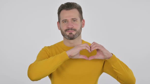 Portrait of Middle Aged Man Showing Heart Shape By Hands