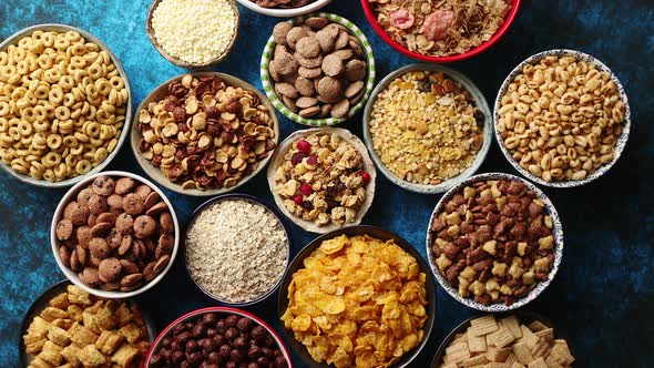 Assortment of Different Kinds Cereals Placed in Ceramic Bowls on Table