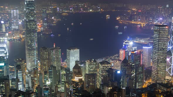 Hong Kong Skyline Urban Panorama at Night Time Lapse China. Zoom Out