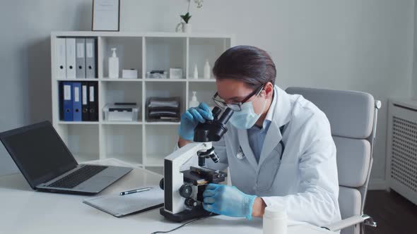 Professional medical doctor working in hospital office using computer technology.