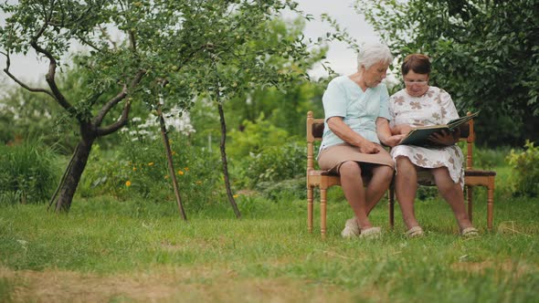 Elder Sister Women View Photos in Old Family Album