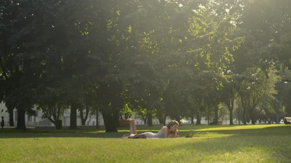 Woman are watching online tv-show outdoors