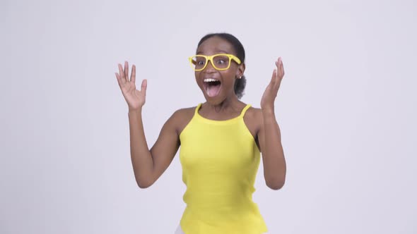 Happy Young African Woman Looking Surprised and Waving Hand