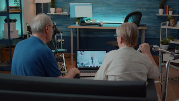 Elder Couple Using Remote Teleconference to Talk to Medic