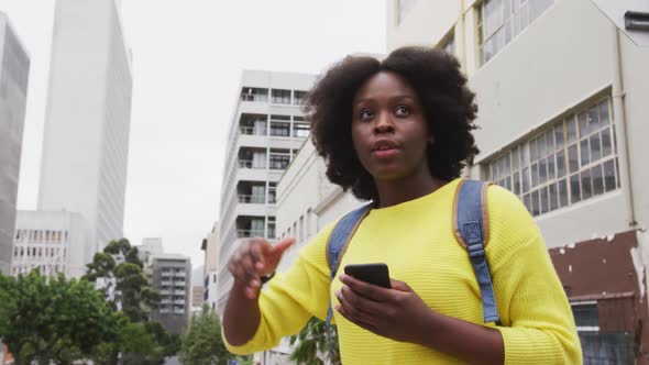 African american raising her hand in street