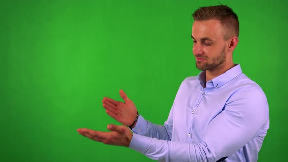 Young Handsome Business Man Introduces Something - Green Screen - Studio