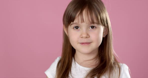 Young Beautiful Happy and Excited Blond Girl 6 or 7 Years Old Holding Donut on Her Eyes