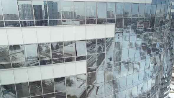Winter City in Reflections of a Highrise Building