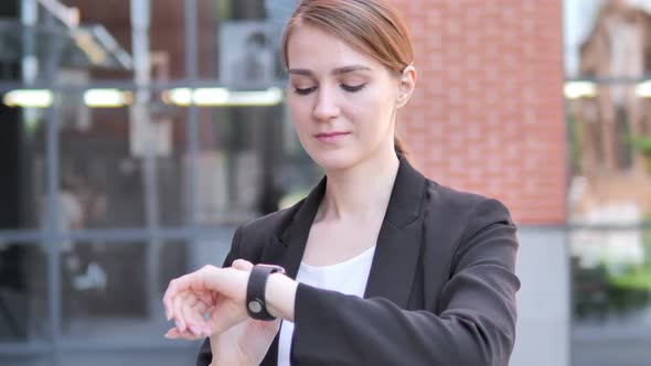 Young Businesswoman Using Smartwatch Outdoor