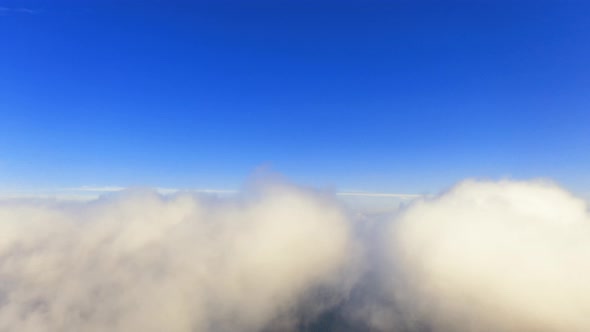 Time lapse aerial view up from the clouds to the sky in motion 