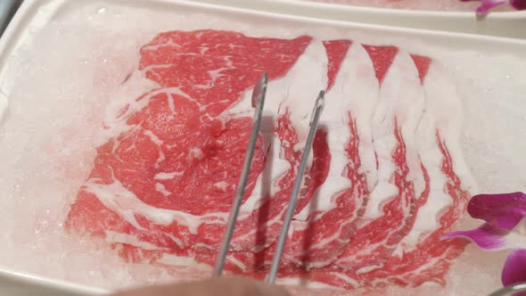 panning close up view of raw wagyu beef sliced ready to make hotpot shabu