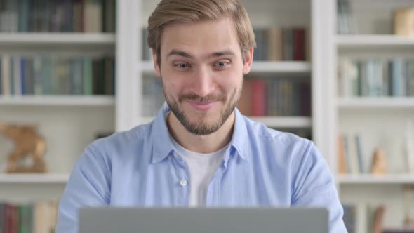 Portrait of Man Celebrating Success While Using Laptop