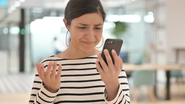 Portrait of Indian Woman Having Loss on Smartphone 