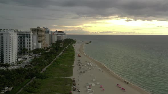 Aerial Miami Beach Bright Sun Through Clouds Over Ocean 4k 60p