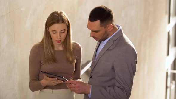 Businesswoman and Businessman with Tablet