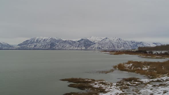 Aerial drone shots of the south end of Utah Lake in the Winter, looking toward the mountains.