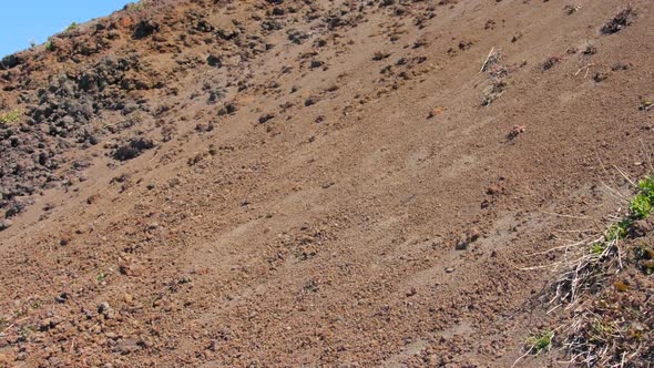 Shot of brown mount Vesuvius exterior slope in Naples, Italy on a bring sunny day. Blue sky visible