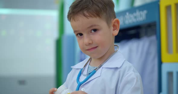 Portrait Cute Preschool Boy in White Medical Uniform Child Playing Hospital Game Posing As a Doctor
