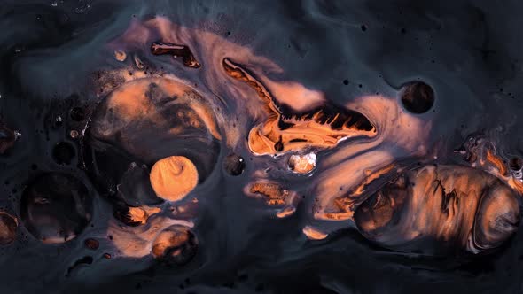 Abstract Golden Paint and Glitter Particles Swirling Around