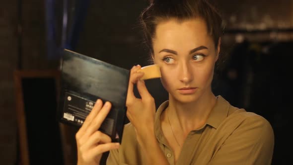 Woman Sponging a Foundation on Her Face