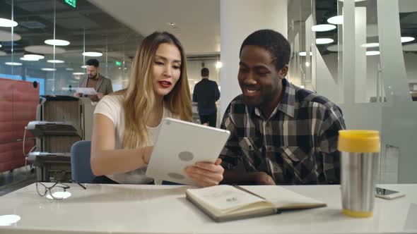 Business Colleagues with Tablet Discussing Ideas