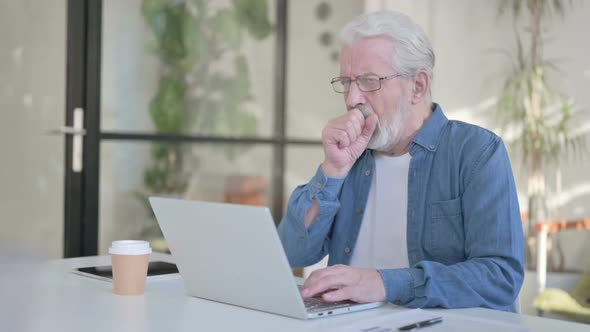 Senior Old Man Having Coughing While Using Laptop in Office