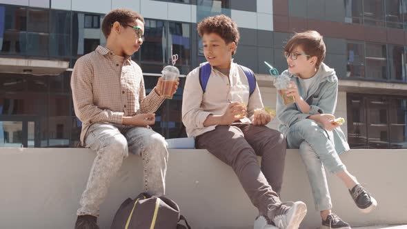 Schoolboys Having Lunch Break Outdoors