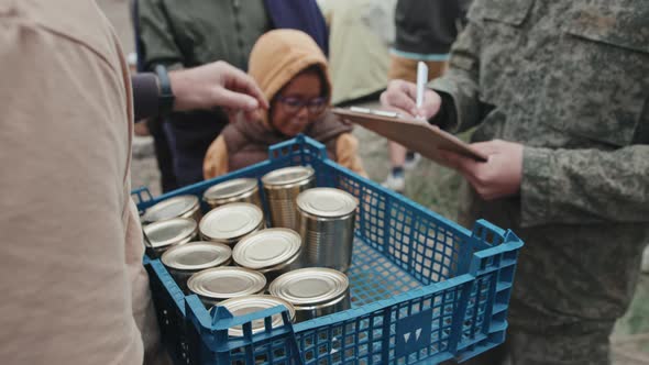 Giving Tinned Food to Refugees at Tent City