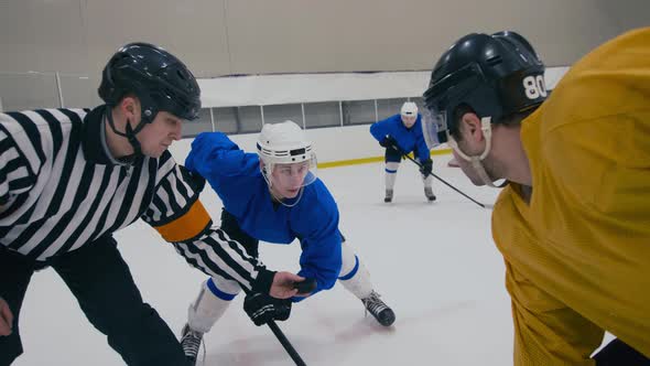 Zoom out shot of ice hockey face-off