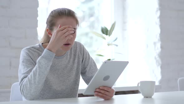 Young Woman Reacting to Financial Loss While Using Tablet