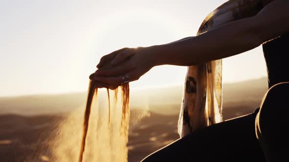 Woman'S Hands Holding And Letting Go Of Desert Sand