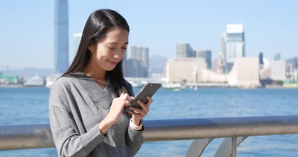 Woman using cellphone in Hong Kong