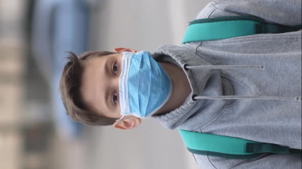 Portrait of a boy in a protective mask on the street..vertical screen