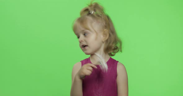 Girl Holds Chamomile Flower and Tells Something. Happy Little Child. Chroma Key