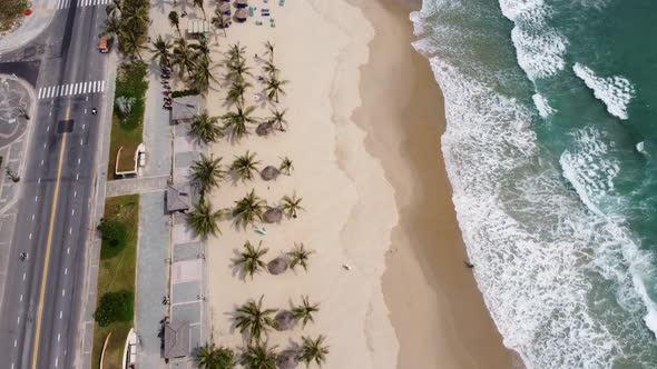 Aerial View of a Road and Majestic White Sand Beach with Surf Waves Brushing on the Seashore on a