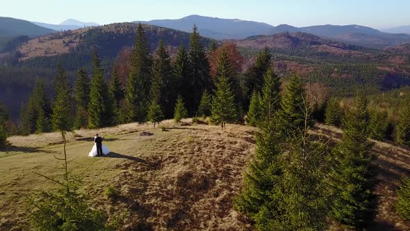 Aerial View Beautiful Couple Walking Against in the Mountains of the Carpathians