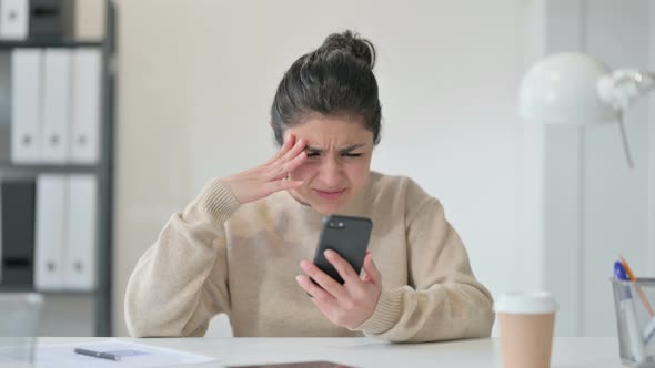 Indian Woman Reacting To Loss on Smartphone 