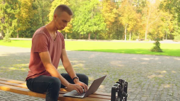 Guy Using Computer Outdoors